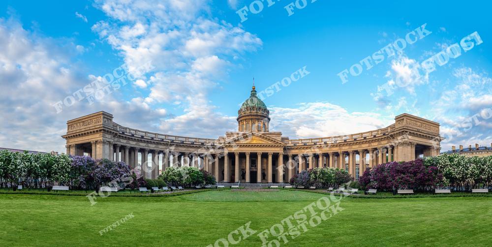На фотографии изображен Казанский собор, один из самых известных православных храмов Санкт-Петербурга. Полукруглая колоннада собора, построенная в стиле ампир, придает зданию величественный и монументальный вид. Здание окружено зелеными газонами и цветущими кустарниками, что подчеркивает его красоту и гармонию с окружающей природой. Собор является важным духовным центром и архитектурной жемчужиной города.